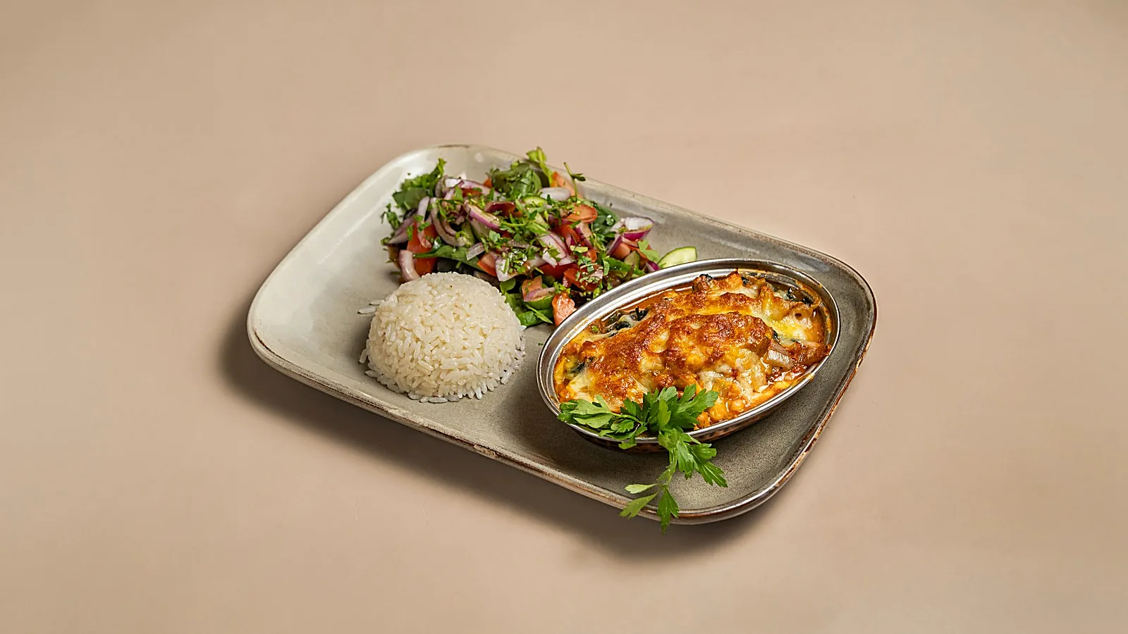 Cheese-topped Turkish bake with rice and salad